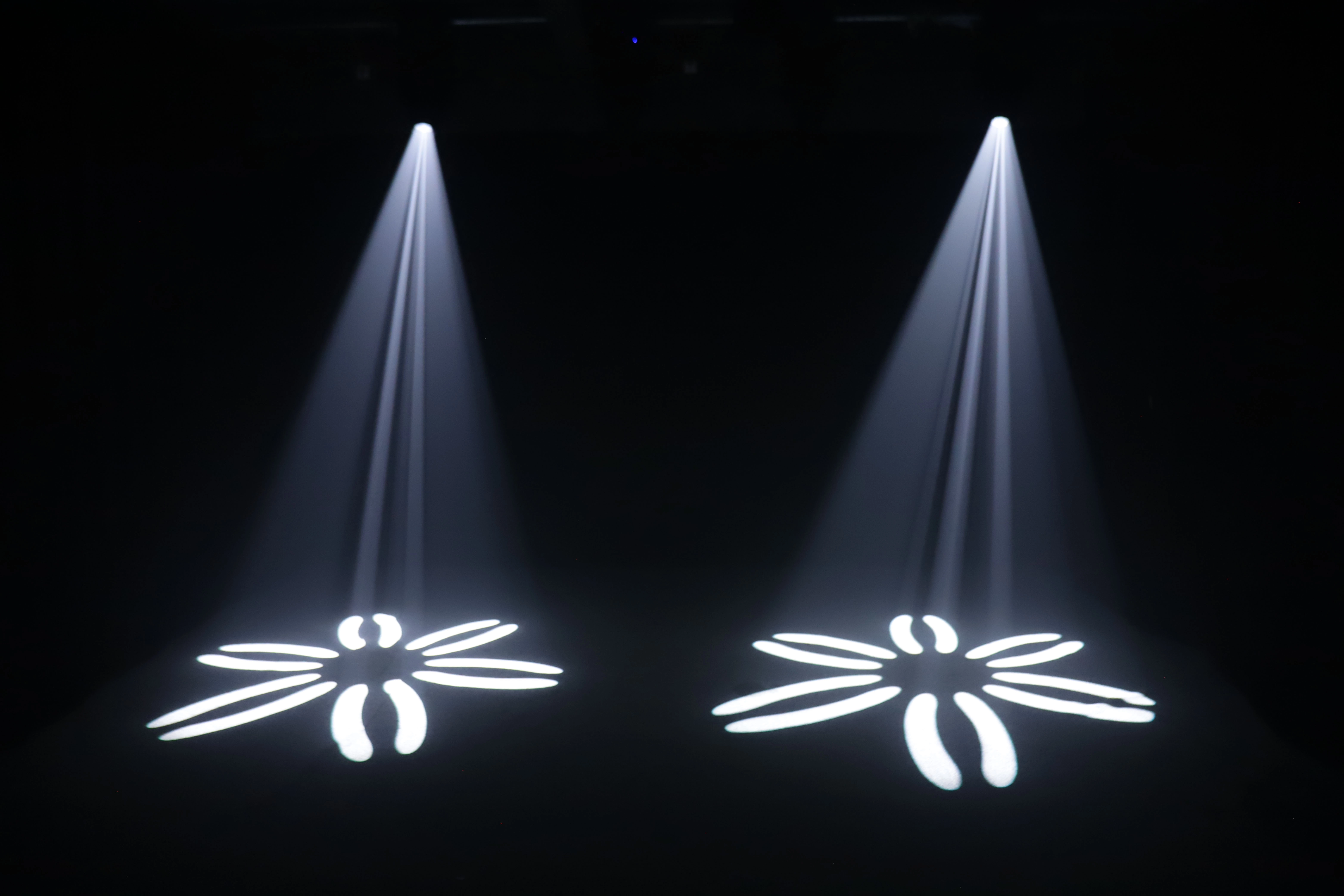 GML ALED BSW 480 CMY LED Moving Head projecting fixed gobo pattern — two units casting geometric shapes onto floor